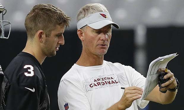Arizona Cardinals offensive coordinator Mike McCoy, right, explains a play to rookie quarterback Jo...