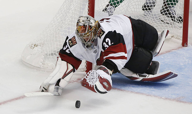 Arizona Coyotes goaltender Antti Raanta reaches for the puck during the third period of an NHL hock...