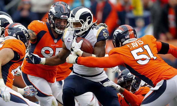 Los Angeles Rams running back Todd Gurley (30) runs as Denver Broncos linebacker Todd Davis (51) an...