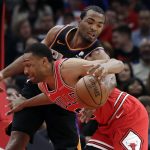 Chicago Bulls forward Jabari Parker, front, drives against Phoenix Suns forward T.J. Warren during the first half of an NBA basketball game Wednesday, Nov. 21, 2018, in Chicago. (AP Photo/Nam Y. Huh)