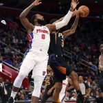 Detroit Pistons center Andre Drummond (0) and Phoenix Suns forward Trevor Ariza (3) reach for a rebound during the first half of an NBA basketball game, Sunday, Nov. 25, 2018, in Detroit. (AP Photo/Carlos Osorio)