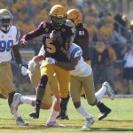 Arizona State quarterback Manny Wilkins (5) runs with the ball as he is tackled by UCLA defensive back Nate Meadors (22) during the first half of an NCAA college football game, Saturday, Nov. 10, 2018, in Tempe, Ariz. (AP Photo/Ralph Freso)