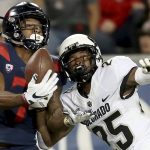 Arizona wide receiver Devaughn Cooper (7) makes a one-handed catch despite being wrapped up by Colorado cornerback Mekhi Blackmon (25) during the second quarter of an NCAA college football game Friday, Nov. 2, 2018, in Tucson, Ariz. (Kelly Presnell/Arizona Daily Star via AP)