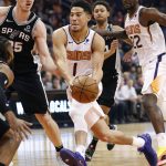 Phoenix Suns guard Devin Booker (1) drives against the San Antonio Spurs during the second half of an NBA basketball game, Wednesday, Nov. 14, 2018, in Phoenix. (AP Photo/Matt York)
