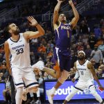 Phoenix Suns guard Devin Booker (1) drives past Memphis Grizzlies center Marc Gasol in the second half during an NBA basketball game, Sunday, Nov. 4, 2018, in Phoenix. The Suns defeated the Grizzlies 102-100. (AP Photo/Rick Scuteri)