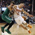 Phoenix Suns guard Devin Booker (1) is fouled by Boston Celtics guard Marcus Smart during the second half of an NBA basketball game Thursday, Nov. 8, 2018, in Phoenix. The Celtics won 116-109 in overtime. (AP Photo/Matt York)