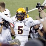 Arizona State quarterback Manny Wilkins celebrates with the fans after defeating Arizona in an NCAA college football game, Saturday, Nov. 24, 2018, in Tucson, Ariz. (AP Photo/Rick Scuteri)