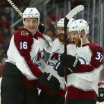 Colorado Avalanche left wing J.T. Compher (37) celebrates his short-handed goal against the Arizona Coyotes with Avalanche defenseman Nikita Zadorov (16) and defenseman Ian Cole, center, during the first period of an NHL hockey game Friday, Nov. 23, 2018, in Glendale, Ariz. (AP Photo/Ross D. Franklin)