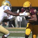 Arizona State wide receiver Kyle Williams, right, fends off the tackle of UCLA safety Adarius Pickett, left, after a catch during the first half of an NCAA college football game, Saturday, Nov. 10, 2018, in Tempe, Ariz. (AP Photo/Ralph Freso)