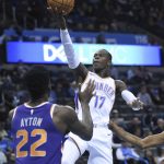 Oklahoma City Thunder guard Dennis Schroder (17) goes up for a shot over Phoenix Suns center Deandre Ayton (22) in the second half of an NBA basketball game in Oklahoma City, Monday, Nov. 12, 2018. (AP Photo/Kyle Phillips)