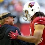 Arizona Cardinals wide receiver Larry Fitzgerald (11) greets Oakland Raiders head coach Jon Gruden prior to an NFL football game, Sunday, Nov. 18, 2018, in Glendale, Ariz. (AP Photo/Ross D. Franklin)