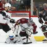 
              Colorado Avalanche goaltender Philipp Grubauer (31) makes a save on a shot by Arizona Coyotes center Alex Galchenyuk (17) as Avalanche defenseman Patrik Nemeth (12) and center Sheldon Dries (15) look on during the first period of an NHL hockey game Friday, Nov. 23, 2018, in Glendale, Ariz. (AP Photo/Ross D. Franklin)
            