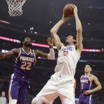 Los Angeles Clippers' Boban Marjanovic (51) grabs a rebound next to Phoenix Suns' Deandre Ayton (22) during the first half of an NBA basketball game Wednesday, Nov. 28, 2018, in Los Angeles. (AP Photo/Marcio Jose Sanchez)