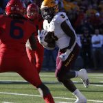 Arizona State running back Eno Benjamin (3) scores a touchdown in front of Arizona safety Demetrius Flannigan-Fowles in the second half during an NCAA college football game, Saturday, Nov. 24, 2018, in Tucson, Ariz. (AP Photo/Rick Scuteri)
