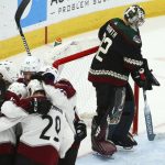 Arizona Coyotes goaltender Antti Raanta, right, pauses in front of the net as Colorado Avalanche defenseman Tyson Barrie (4) celebrates his goal with right wing Mikko Rantanen (96), center Nathan MacKinnon (29) and left wing Gabriel Landeskog (92) during the third period of an NHL hockey game Friday, Nov. 23, 2018, in Glendale, Ariz. (AP Photo/Ross D. Franklin)