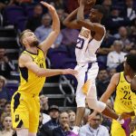 Phoenix Suns forward Josh Jackson (20) passes over Indiana Pacers forward Domantas Sabonis during the first half of an NBA basketball game, Tuesday, Nov. 27, 2018, in Phoenix. (AP Photo/Matt York)