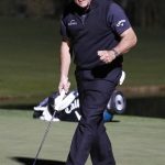 Phil Mickelson celebrates after sinking a put to defeat Tiger Woods at a playoff hole in a golf match at Shadow Creek golf course, Friday, Nov. 23, 2018, in Las Vegas. (AP Photo/John Locher)