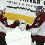 Colorado Avalanche goaltender Philipp Grubauer (31) celebrates with left wing J.T. Compher (37) as time expires in the third period of an NHL hockey game against the Arizona Coyotes, Friday, Nov. 23, 2018, in Glendale, Ariz. (AP Photo/Ross D. Franklin)