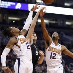 Phoenix Suns forward TJ Warren (12) battles San Antonio Spurs forward Rudy Gay and Phoenix Suns forward Richaun Holmes, left, for the rebound during the first half of an NBA basketball game, Wednesday, Nov. 14, 2018, in Phoenix. (AP Photo/Matt York)