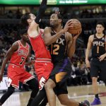 Phoenix Suns forward T.J. Warren, right, drives against Chicago Bulls guard Ryan Arcidiacono during the first half of an NBA basketball game Wednesday, Nov. 21, 2018, in Chicago. (AP Photo/Nam Y. Huh)