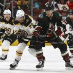 Arizona Coyotes right wing Christian Fischer (36) battles with Boston Bruins left wing Jake DeBrusk (74) for the puck as Bruins center Joakim Nordstrom (20) and Coyotes center Brad Richardson (15) watch during the second period of an NHL hockey game Saturday, Nov. 17, 2018, in Glendale, Ariz. (AP Photo/Ross D. Franklin)