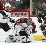 Colorado Avalanche goaltender Philipp Grubauer (31) makes a save on a shot by Arizona Coyotes center Alex Galchenyuk (17) as Avalanche defenseman Patrik Nemeth (12) and center Sheldon Dries (15) look on during the first period of an NHL hockey game Friday, Nov. 23, 2018, in Glendale, Ariz. (AP Photo/Ross D. Franklin)