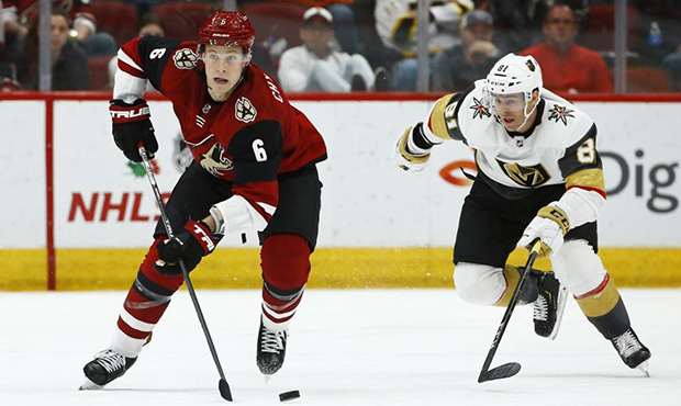 Arizona Coyotes defenseman Jakob Chychrun (6) skates with the puck in front of Vegas Golden Knights...