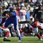 Los Angeles Chargers' Melvin Gordon (28) runs for a touchdown past Arizona Cardinals middle linebacker Josh Bynes (57) during the first half of an NFL football game Sunday, Nov. 25, 2018, in Carson, Calif. (AP Photo/Kelvin Kuo )