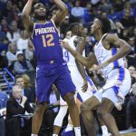 Phoenix Suns forward T.J. Warren (12) shoots the ball over Oklahoma City Thunder center Nerlens Noel (3) in the first half of an NBA basketball game in Oklahoma City, Monday, Nov. 12, 2018. (AP Photo/Kyle Phillips)