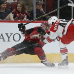 Carolina Hurricanes left wing Jordan Martinook (48) drags down Arizona Coyotes center Alex Galchenyuk for a tripping penalty during the first period of an NHL hockey game Friday, Nov. 2, 2018, in Glendale, Ariz. (AP Photo/Rick Scuteri)