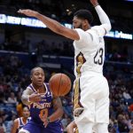 Phoenix Suns guard Isaiah Canaan (0) passes around New Orleans Pelicans forward Anthony Davis (23) in the first half of an NBA basketball game in New Orleans, Saturday, Nov. 10, 2018. (AP Photo/Gerald Herbert)