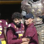 An emotional Arizona State quarterback Manny Wilkins (5) embraces head coach Herm Edwards as he is introduced for his final game at Sun Devil Stadium prior to an NCAA college football game against UCLA, Saturday, Nov. 10, 2018, in Tempe, Ariz. (AP Photo/Ralph Freso)