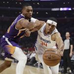 Los Angeles Clippers' Tobias Harris (34) reaches for a loose ball next to Phoenix Suns' Mikal Bridges during the first half of an NBA basketball game Wednesday, Nov. 28, 2018, in Los Angeles. (AP Photo/Marcio Jose Sanchez)