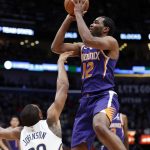 Phoenix Suns forward TJ Warren (12) shoots as he is fouled byNew Orleans Pelicans forward Wesley Johnson (33) in the first half of an NBA basketball game in New Orleans, Saturday, Nov. 10, 2018. (AP Photo/Gerald Herbert)
