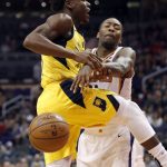 Indiana Pacers guard Aaron Holiday is fouled by Phoenix Suns guard Jamal Crawford, right, during the first half of an NBA basketball game, Tuesday, Nov. 27, 2018, in Phoenix. (AP Photo/Matt York)