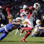 Arizona Cardinals running back David Johnson (31) is tackled by Los Angeles Chargers defensive back Adrian Phillips during the first half of an NFL football game Sunday, Nov. 25, 2018, in Carson, Calif. (AP Photo/Jae C. Hong )