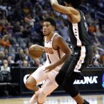 Phoenix Suns guard Devin Booker (1) drives by Brooklyn Nets center Jarrett Allen during the second half of an NBA basketball game Tuesday, Nov. 6, 2018, in Phoenix. The Nets won 104-82. (AP Photo/Rick Scuteri)