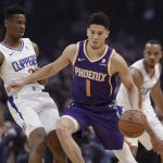 Phoenix Suns' Devin Booker (1) is defended by Los Angeles Clippers' Shai Gilgeous-Alexander during the first half of an NBA basketball game Wednesday, Nov. 28, 2018, in Los Angeles. (AP Photo/Marcio Jose Sanchez)