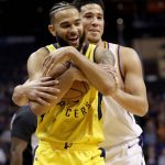 Indiana Pacers guard Cory Joseph and Phoenix Suns guard Devin Booker, right, laugh during a time out during the first half of an NBA basketball game, Tuesday, Nov. 27, 2018, in Phoenix. (AP Photo/Matt York)
