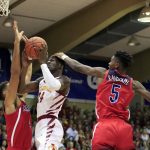 Iowa State guard Terrence Lewis (24) goes between Arizona center Chase Jeter (4) and guard Brandon Randolph (5) during the first half of an NCAA college basketball game at the Maui Invitational, Monday, Nov. 19, 2018, in Lahaina, Hawaii. (AP Photo/Marco Garcia)