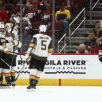 From left to right, Vegas Golden Knights defenseman Shea Theodore, right wing Alex Tuch, left wing Max Pacioretty, center Cody Eakin and defenseman Deryk Engelland celebrate Pacioretty's goal as Arizona Coyotes right wing Richard Panik skates away during the second period of an NHL hockey game Wednesday, Nov. 21, 2018, in Glendale, Ariz. (AP Photo/Ross D. Franklin)