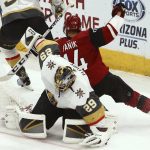 Arizona Coyotes right wing Richard Panik (14) collides with Vegas Golden Knights goaltender Marc-Andre Fleury (29) during the first period of an NHL hockey game Wednesday, Nov. 21, 2018, in Glendale, Ariz. (AP Photo/Ross D. Franklin)