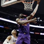 Phoenix Suns' Deandre Ayton, right, scores past Los Angeles Clippers' Tobias Harris during the second half of an NBA basketball game Wednesday, Nov. 28, 2018, in Los Angeles. (AP Photo/Marcio Jose Sanchez)