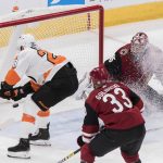 Philadelphia Flyers' Claude Giroux puts the puck in the net against the Arizona Coyotes goalie Darcy Kuemper (35) as teammate Alex Goligoski (33) looks on during the third period of an NHL hockey game Monday, Nov. 5, 2018, in Glendale, Ariz. (AP Photo/Darryl Webb)