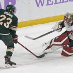 Arizona Coyotes goalie Antti Raanta, right, of Finland, stops a shot by Minnesota Wild's J.T. Brown during the first period of an NHL hockey game Tuesday, Nov. 27, 2018, in St. Paul, Minn. (AP Photo/Jim Mone)