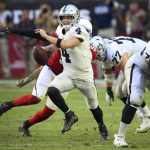 Oakland Raiders quarterback Derek Carr (4) looks to pass under pressure against the Arizona Cardinals during the first half of an NFL football game, Sunday, Nov. 18, 2018, in Glendale, Ariz. (AP Photo/Ross D. Franklin)