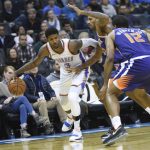 Oklahoma City Thunder forward Paul George (13) tries to push past Phoenix Suns forward Trevor Ariza (3) and T.J. Warren (12) in the second half of an NBA basketball game in Oklahoma City, Monday, Nov. 12, 2018. (AP Photo/Kyle Phillips)