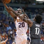 Phoenix Suns forward Josh Jackson (20) is fouled by Brooklyn Nets forward Ed Davis during the second half of an NBA basketball game Tuesday, Nov. 6, 2018, in Phoenix. The Nets won 104-82. (AP Photo/Rick Scuteri)