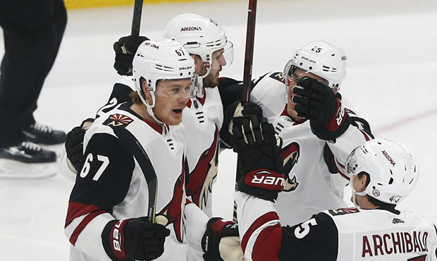 Arizona Coyotes' Lawson Crouse, left, is congratulated by teammates after his goal against the Minn...