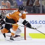 Philadelphia Flyers' Nolan Patrick (19) reaches for a loose puck against Arizona Coyotes' Darcy Kuemper (35) and Niklas Hjalmarsson (4) during the first period of an NHL hockey game, Thursday, Nov. 8, 2018, in Philadelphia. (AP Photo/Matt Slocum)